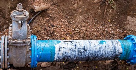 waterworks pipe exposed in soil